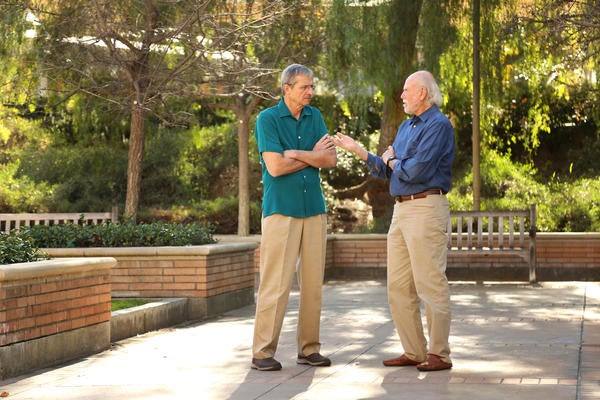 Laureates standing together in courtyard engaging