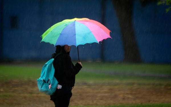 Student with Rainbow Umbrella on Campus