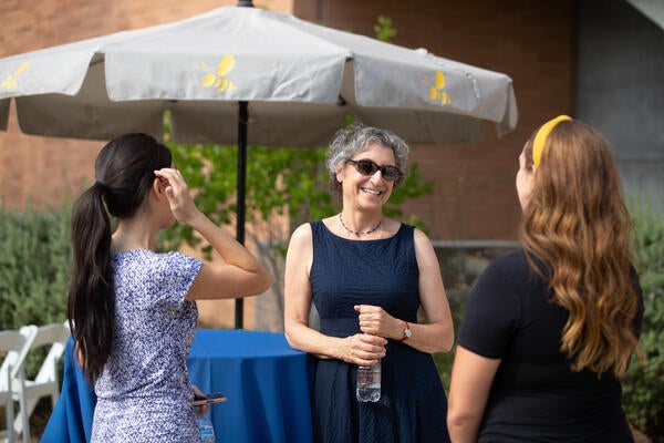 Provost Liz Watkins at Provost Reception greeting two others