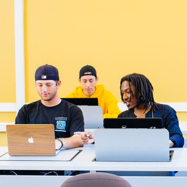 Students working in a computer classroom cropped